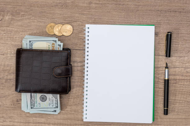 istock notepad with pen, calculator, dollar bills on desk. 667752098