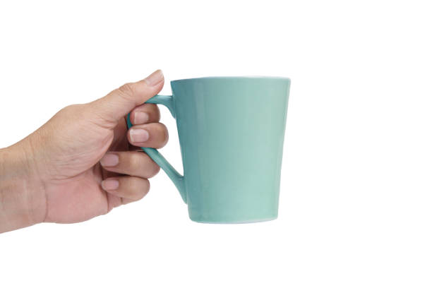 istock Hand holding a green cup of coffee. 667754916