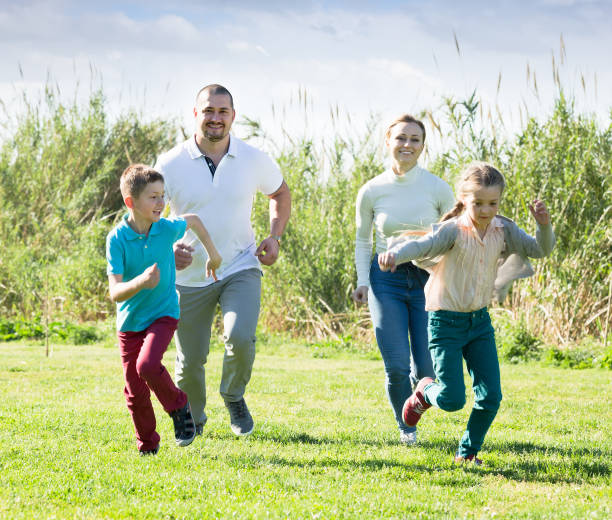 istock Joyful parents with children outdoor 667764112