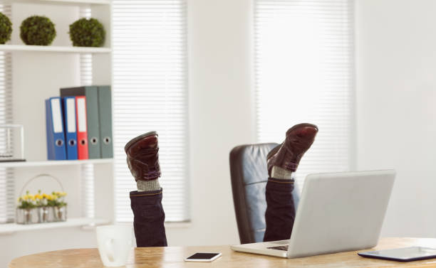istock Businessman upside down at his desk 667764556