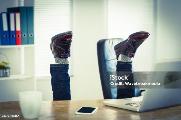 Businessman Upside Down At His Desk Stock Photo - Download Image Now - Upside Down, Men, Office