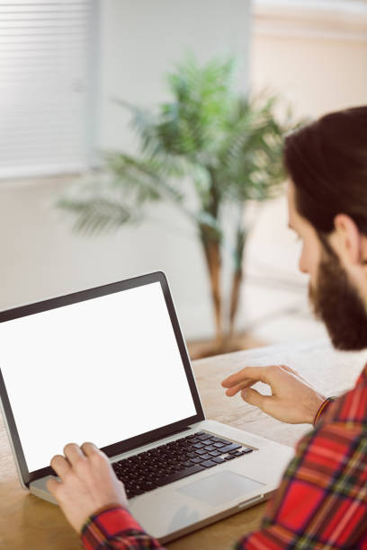 istock Hipster businessman working on his laptop 667766830