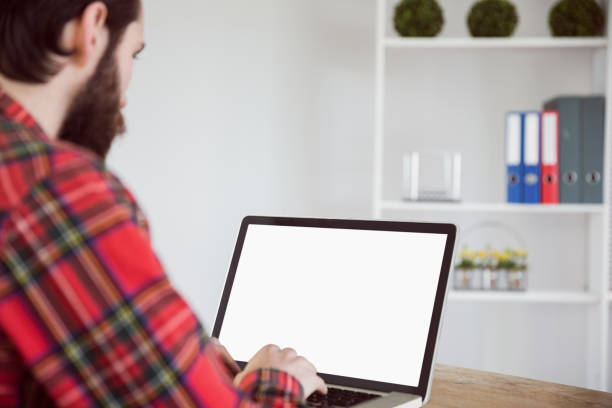 istock Hipster businessman working on his laptop 667766980