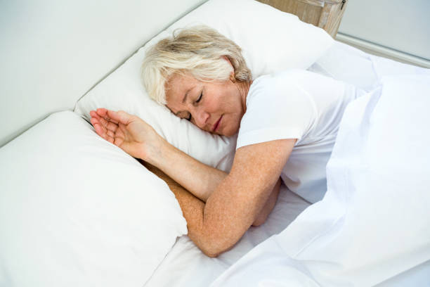 istock High angle view of old woman sleeping 667767400