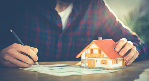 istock Hipster businessman applying for a mortgage 667767582