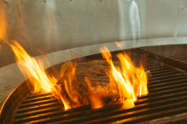 istock Beef grill on stove in five star hotel restaurant for luxury dinner party, Blurry background vintage color style. 667768018