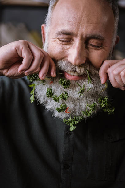istock Senior man with greens in beard 667768126