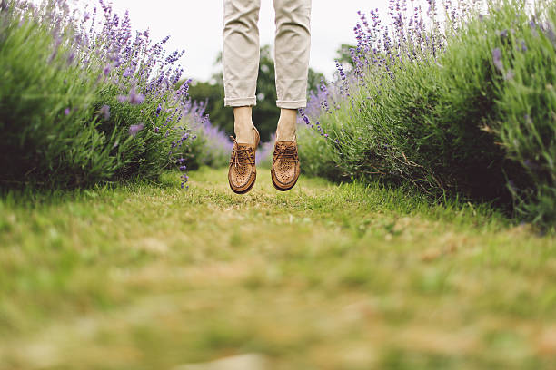 istock Low Section Of A Person Jumping Between Lavender Rows 667770227