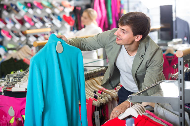 istock Young man in the sport clothes shop 667770638