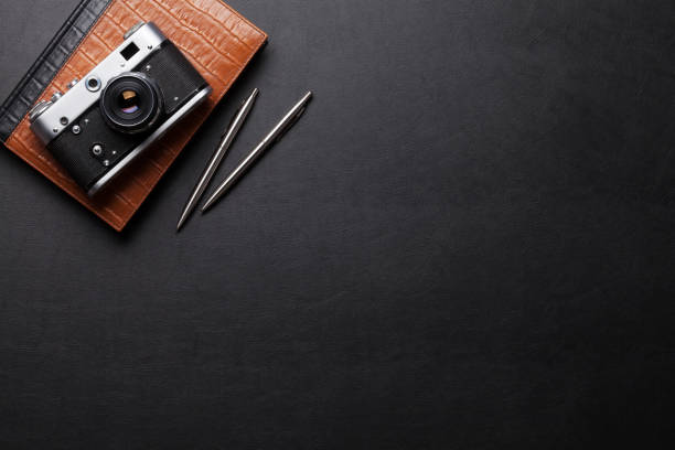istock Office desk with camera, notepad, pen and pencil 667770858