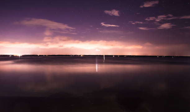 moonlight long exposure over a lake stock photo