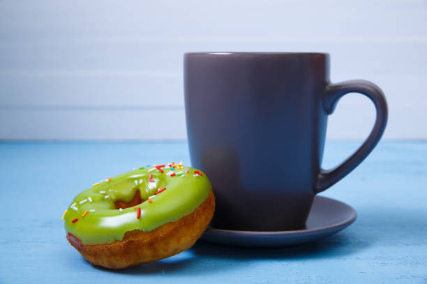 istock Donut with cup. Sweet glazed dessert. On wood. 667777644