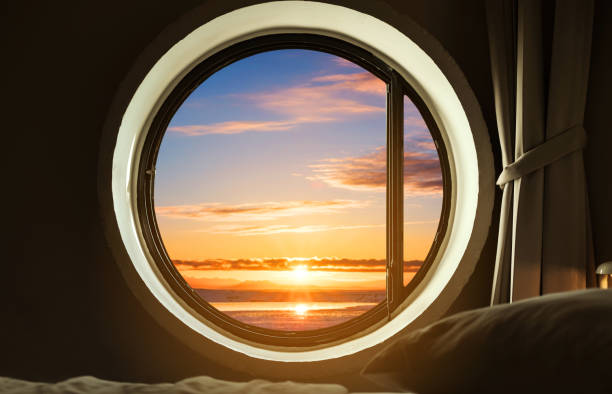 istock Interior bedroom circle window with beautiful sunrise view 667778700
