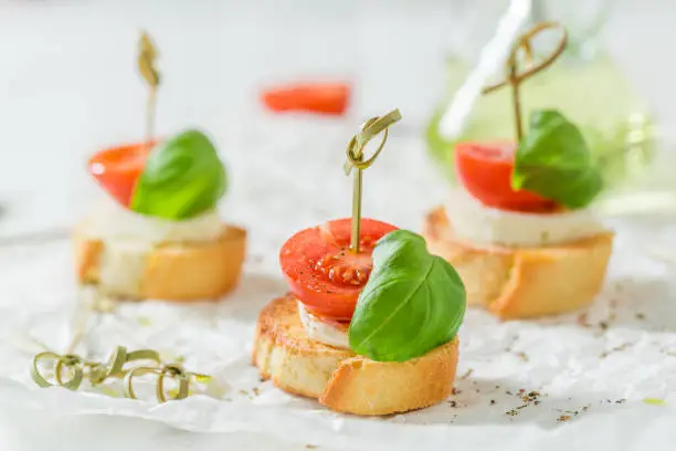 Delicious crostini with tomato, mozzarella and basil for a snack