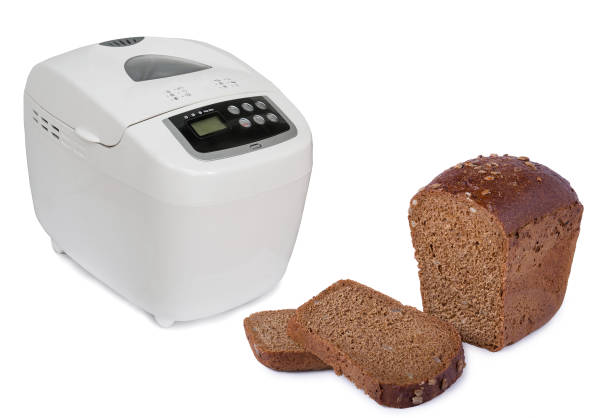 istock Electric bread maker and sliced rye bread with seeds  isolated on white background 667782510