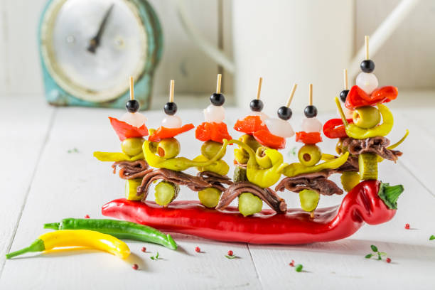 tasty banderillas with peppers, olives and anchovies for a party - olive green olive stuffed food imagens e fotografias de stock