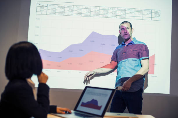 istock Businessman standing in a front of a projector doing a presentation 667790638