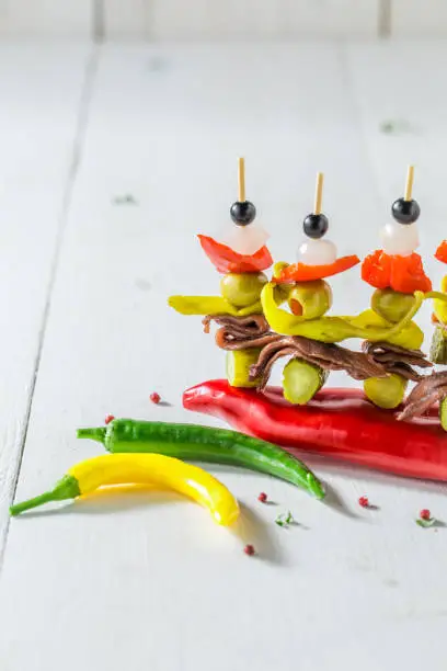 Tasty banderillas with peppers, olives and anchovies for spanish corrida