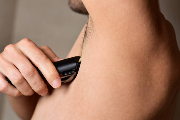 istock man trimming his armpit with an electric trimmer 667791344