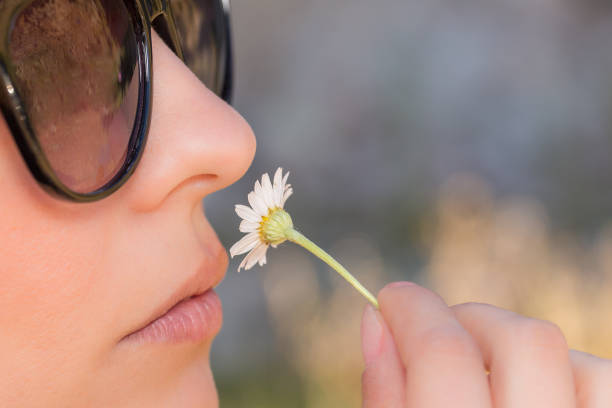 istock Pretty girl smelling flower 667794736