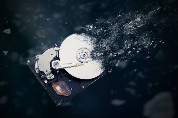 the old hard disk drive is disintegrating in space. - destruição imagens e fotografias de stock