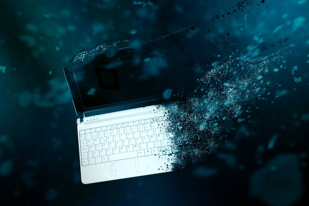 istock The old laptop is disintegrating in space. 667795566
