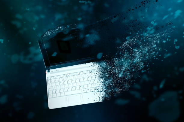 The old laptop is disintegrating in space. The old laptop is disintegrating in space. Conception of passage of time and obsolete technology disintegration stock pictures, royalty-free photos & images