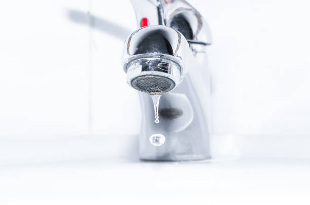 istock Dripping faucet close up on white background 667799204