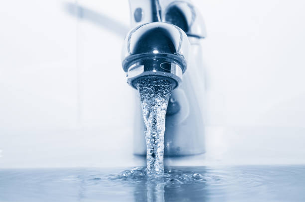 istock Faucet with flowing water closeup 667799398