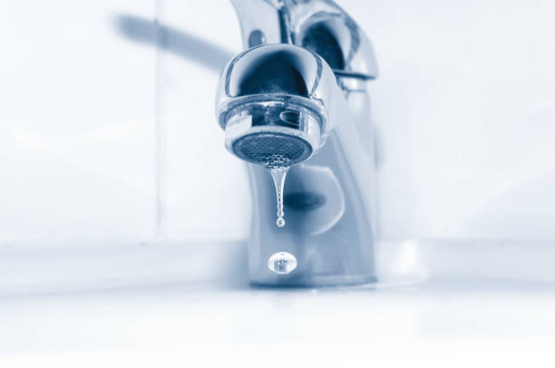 istock Faucet and water drops close up 667799566