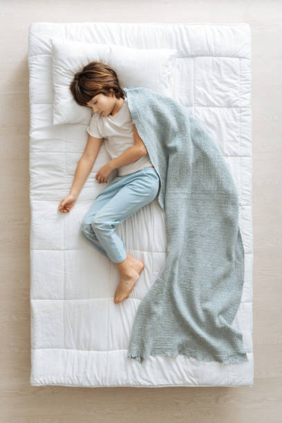 istock Serene dreamy kid covered with blue blanket 667802304