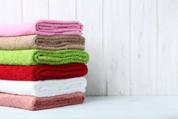istock Towels on white wooden wall paneling background 667809732