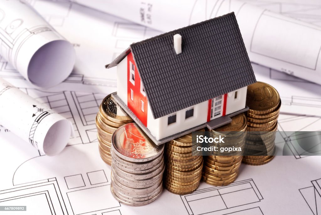 House on stacks with coins House stands on stacks of coins. Prosperity Stock Photo