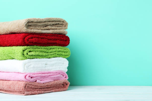 istock Colorful towels on green background 667810436