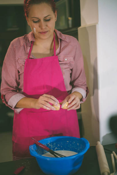 istock Woman whisking batter in kitchen 667812858