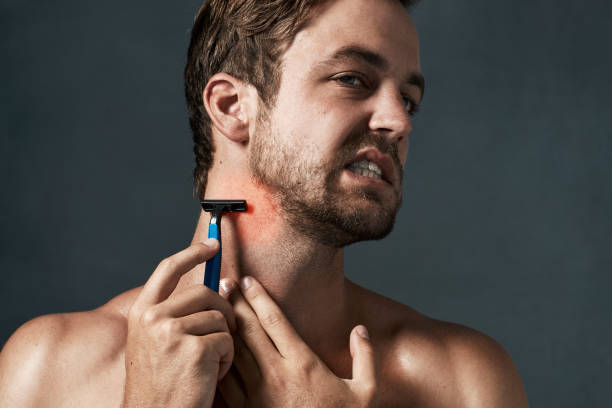 Is your shaving regimen causing your problems? Cropped shot of a handsome young man grimacing while shaving blunts stock pictures, royalty-free photos & images