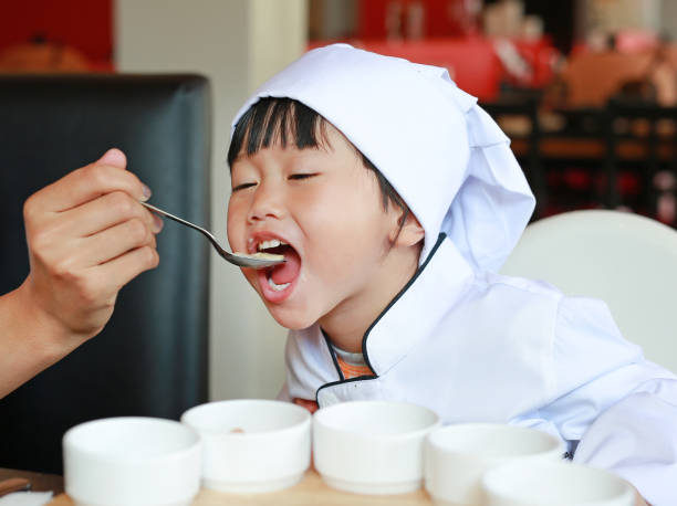 istock Little chief is learn eating tasty food. 667816962