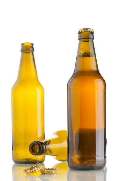 istock One bottle with beer and two empty beer bottles on white background 667819550