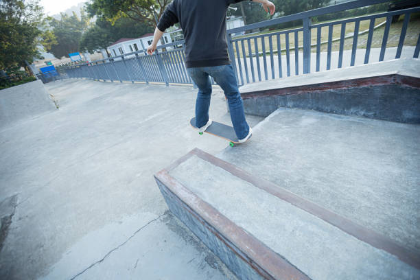 istock young skateboarder legs riding skateboard at skatepark 667820036