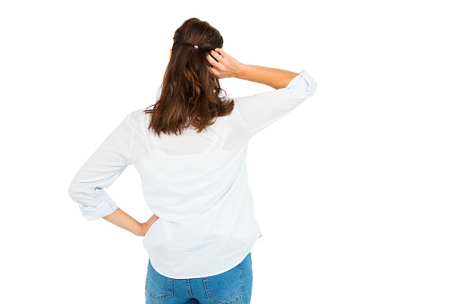 Rear view of woman scratching her head on white background