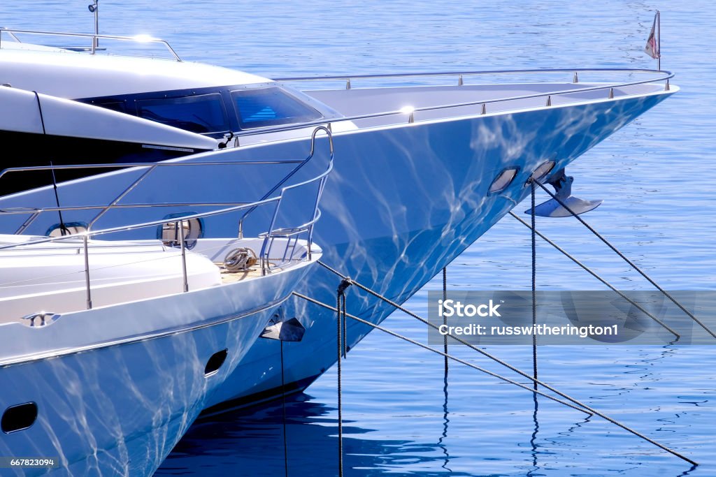 Water reflection the bows of luxury yachts moored  with refection of water Yacht Stock Photo