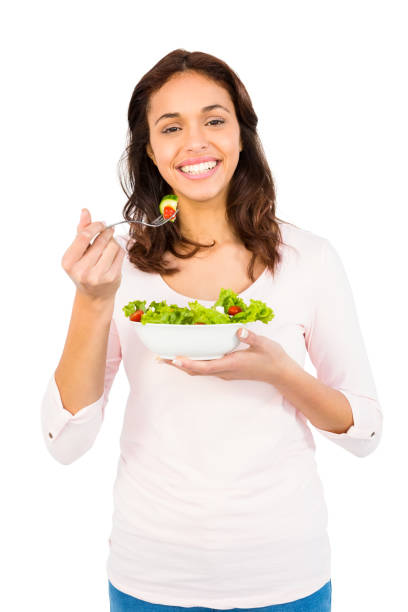 istock Pretty smiling woman eating salad 667823394