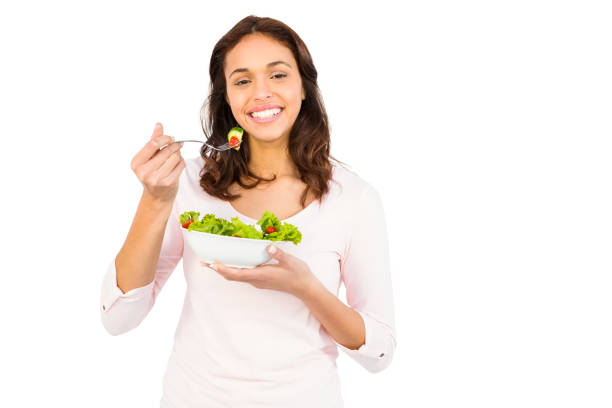 istock Pretty smiling woman eating salad 667823404