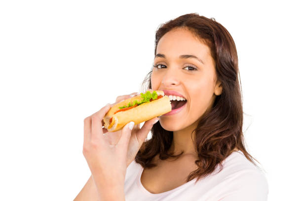 istock Smiling woman eating sandwich 667823444