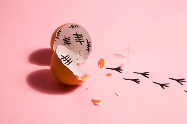 The counting of the days on a broken egg with footprint on a pink and blue background