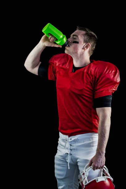 istock American football player drinking 667824094