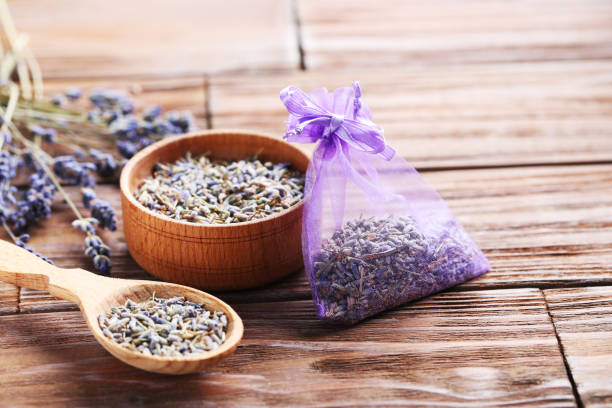 istock Lavender flowers in bowl and spoon on brown table 667824690