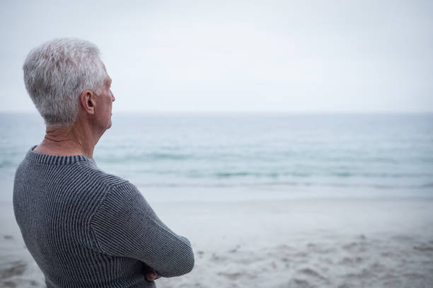 istock Senior man looking at sea 667824898