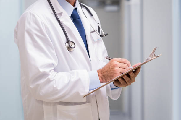 istock Doctor with medical report 667825124