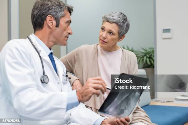 Doctor And Senior Patient Stock Photo - Download Image Now - Doctor, Osteoporosis, Patient